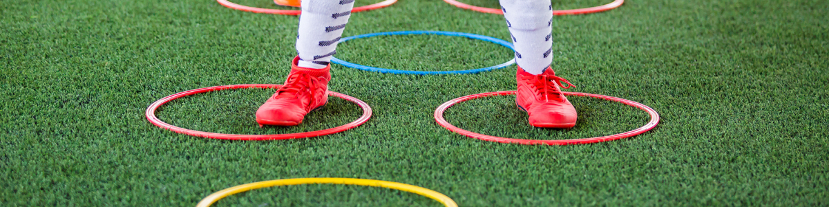 Child participating in a training trill on a grass oval