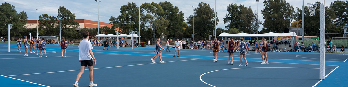 Outdoor netball courts with netball players running around