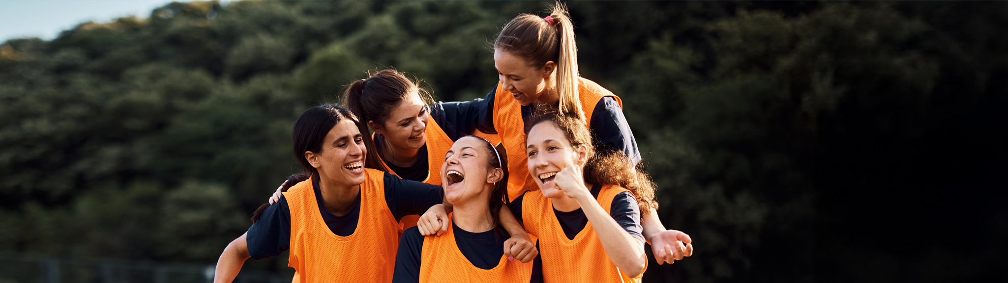 Women in sporting uniforms celebrating