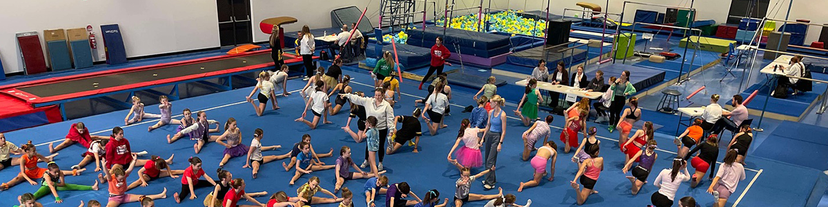 Gymnastics students stretching in the Paul Murray Recreation Centre